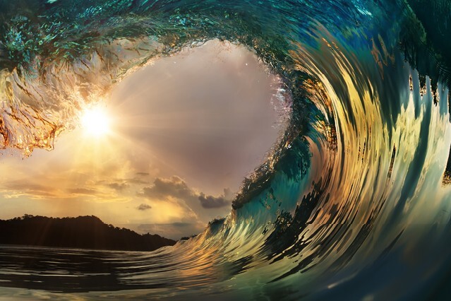 Beautiful ocean surfing wave at sunset